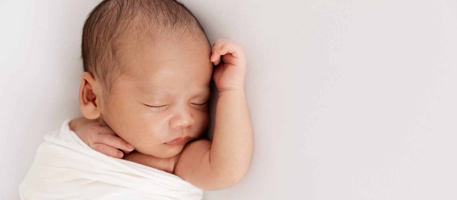 A peacefully sleeping swaddled newborn